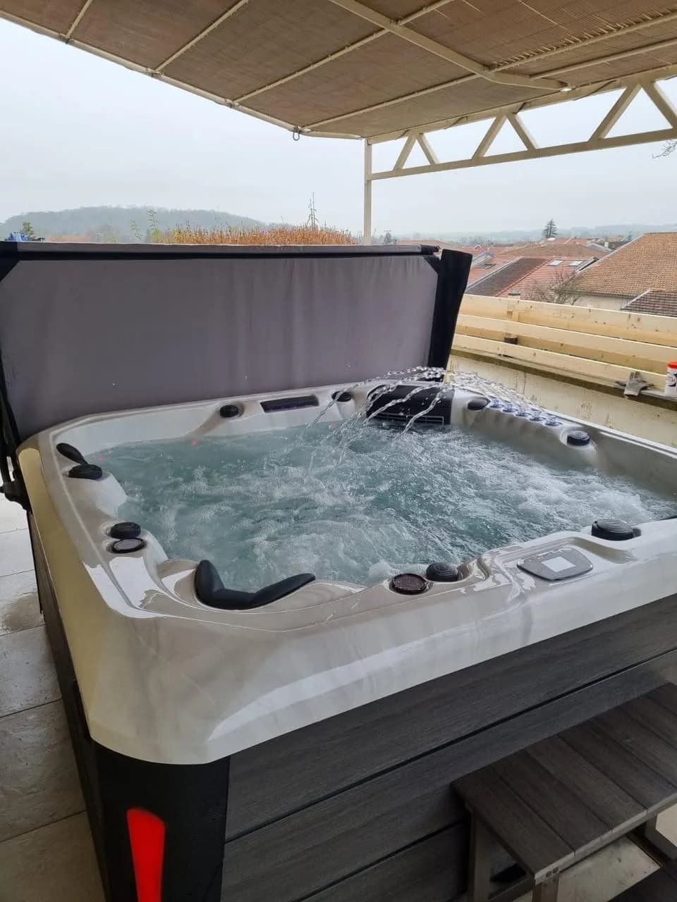 Installation d'un spa Barcelona à Void-Vacon, sur une terrasse sous un store