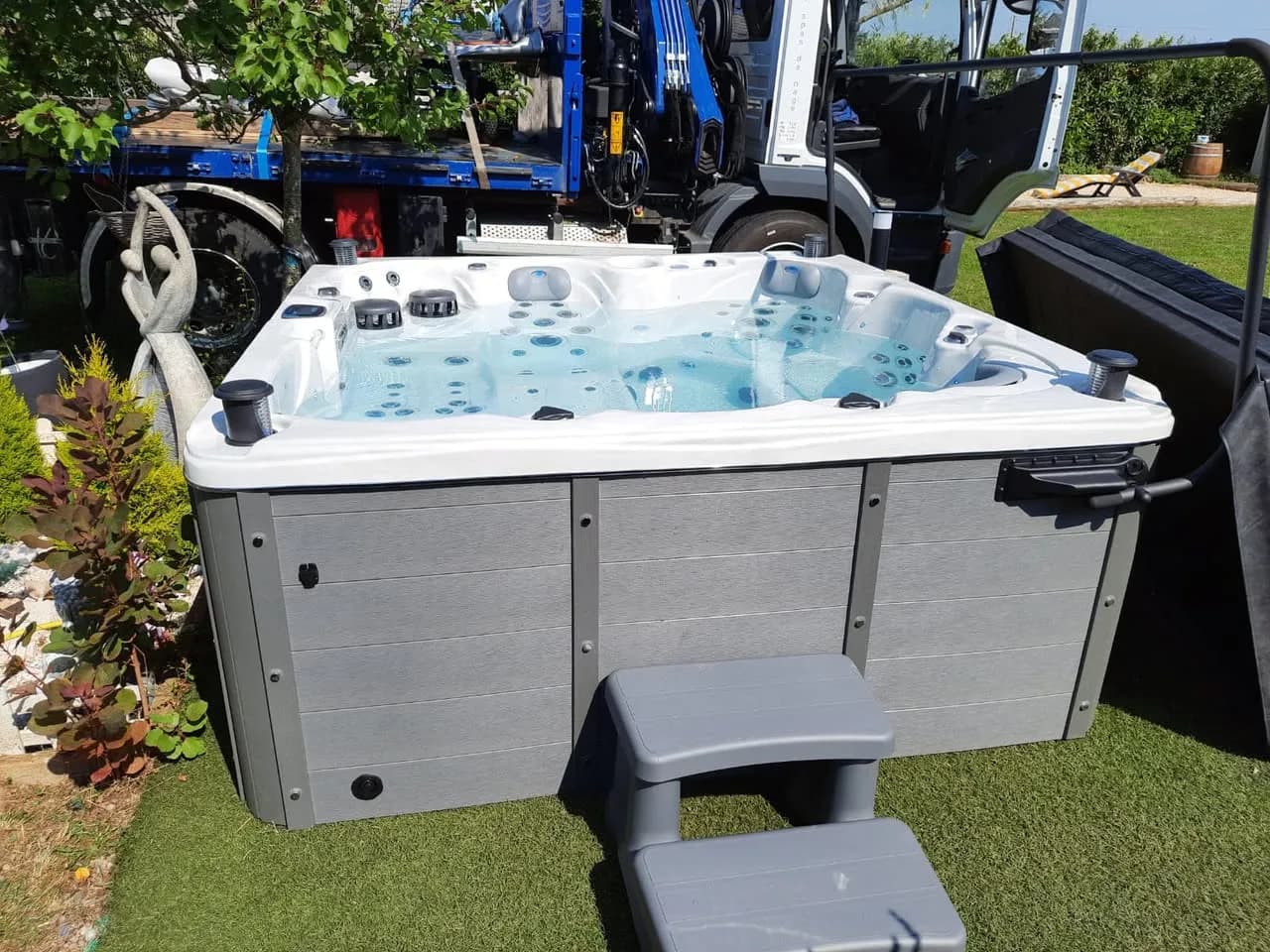 Installation d'un spa Cambridge Duel Full option à Vézelise, dans un jardin, lève-couverture