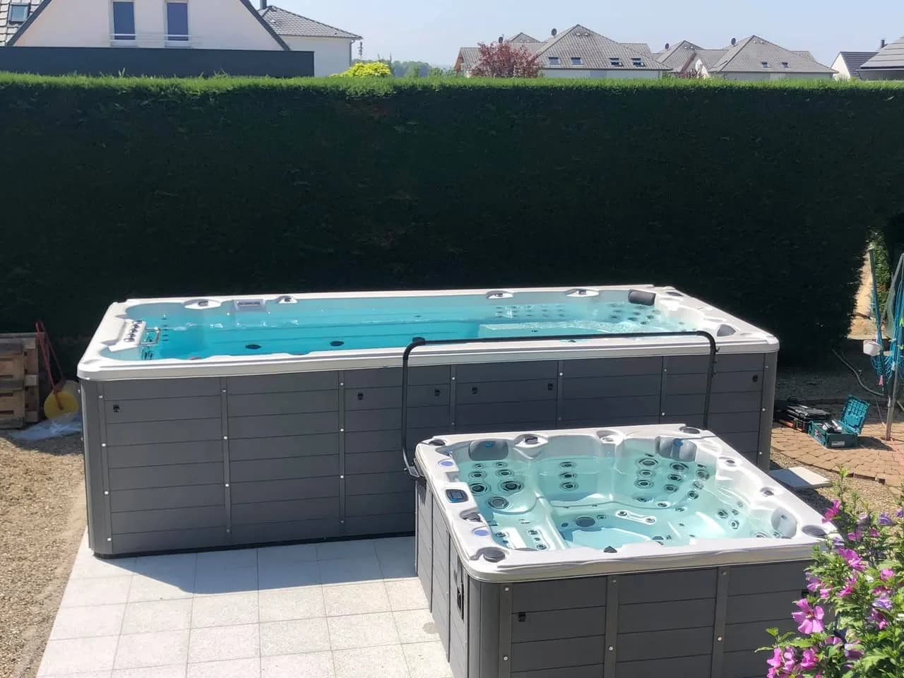 Installation d'un spa de nage Waterloo 501 à Battenheim, sur une dalle avec un spa Ottawa devant