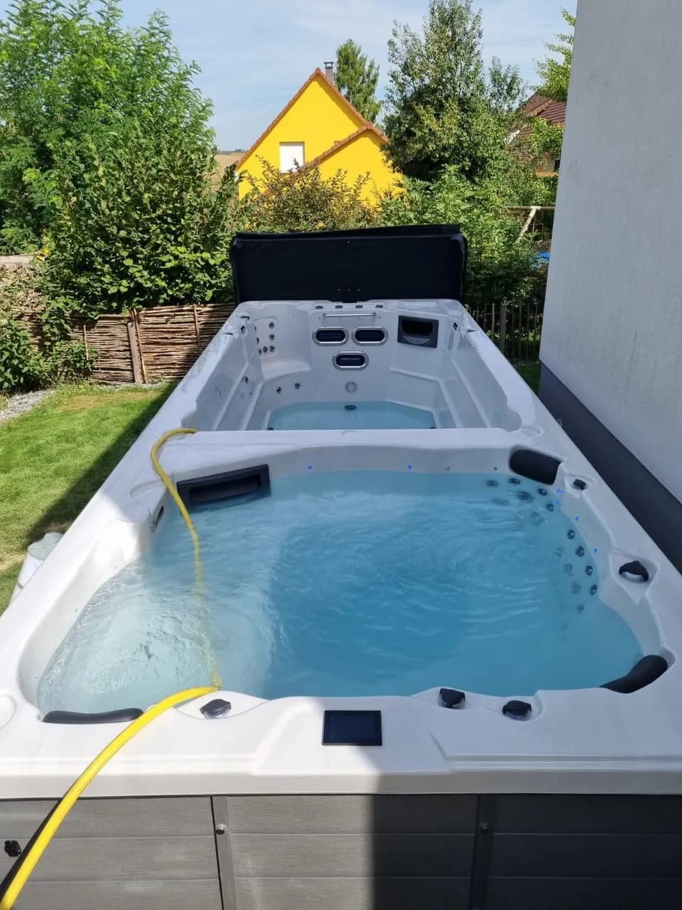 Installation d'un spa de nage Waterloo 594 à Brinckheim, spa de nage bi-zone dans le jardin