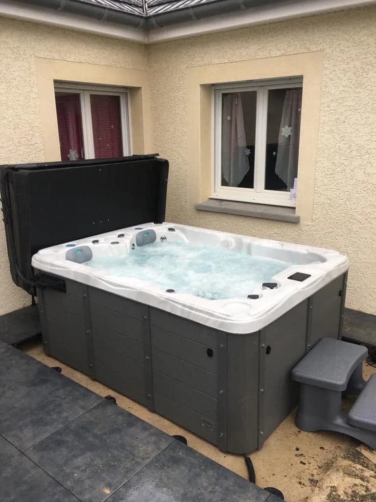 Installation d'un spa Montana à Étang-sur-Arroux, dans une cour, marchepied et lève-couverture