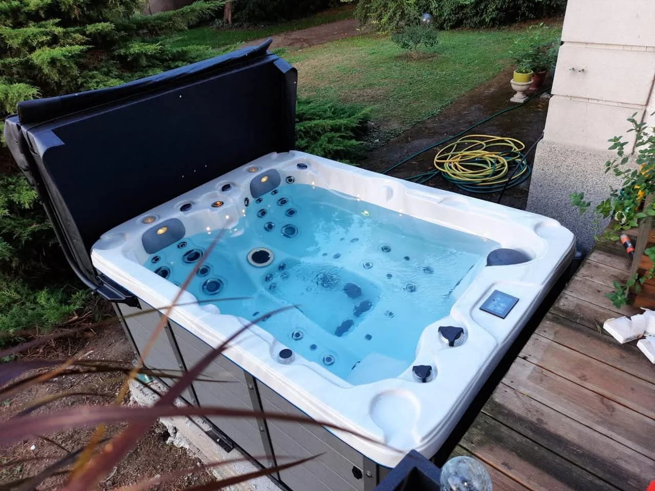 Installation d'un spa Montana à Illfurth, sur une terrasse en bois, lève-couverture