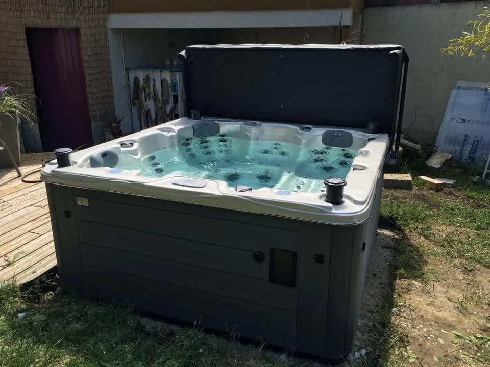 Installation d'un spa Ottawa à Drusenheim, sur une terrasse en bois, lève-couverture