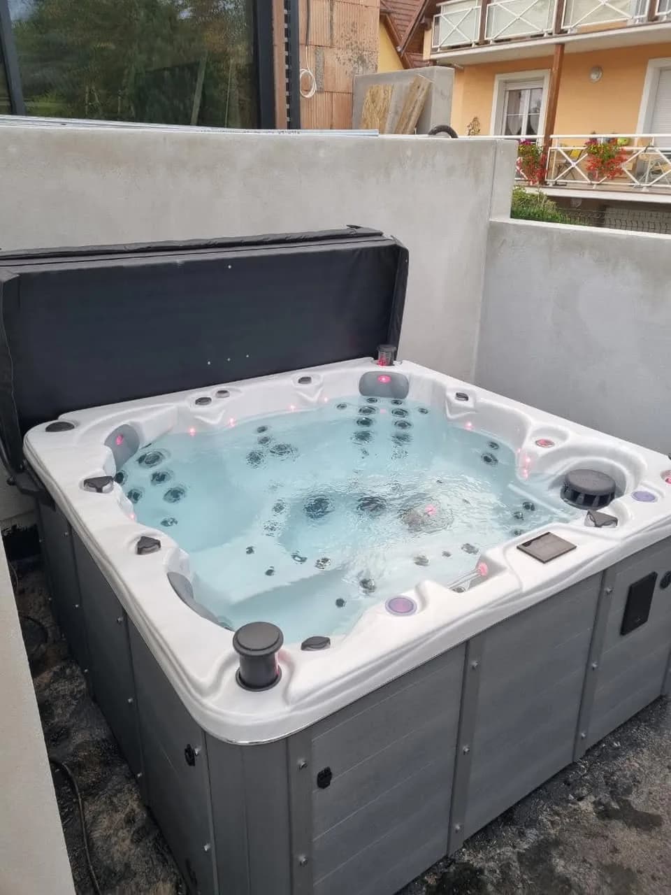 Installation d'un spa Québec Full option à Baldersheim, contre un mur, lève-couverture