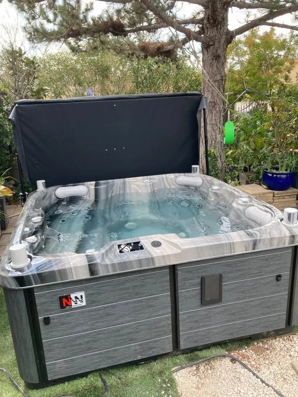 Installation d'un spa Sørrana Full option à Vitrolles, sur la pelouse dans un jardin arboré