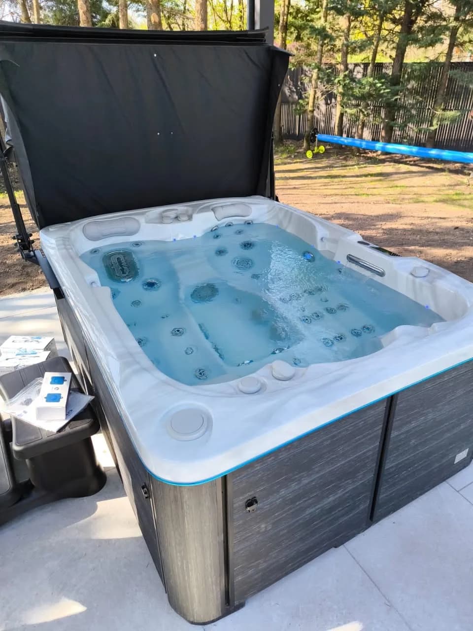 Installation d'un spa Tønsberg à Cernay, sur une dalle, couverture relevée