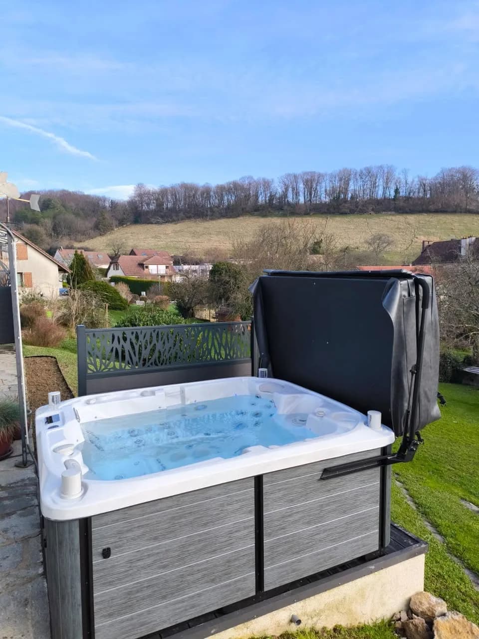 Installation d'un spa Tønsberg à Thise, sur une terrasse avec vue sur la campagne