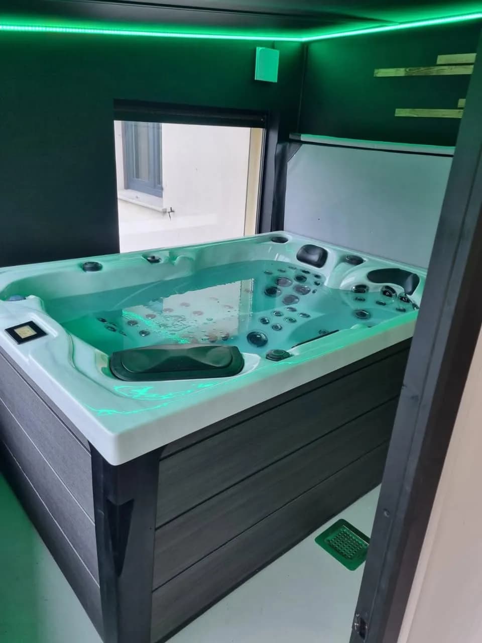 Installation d'un spa Topaz à Baldersheim, sous un abri à éclairage LED vert