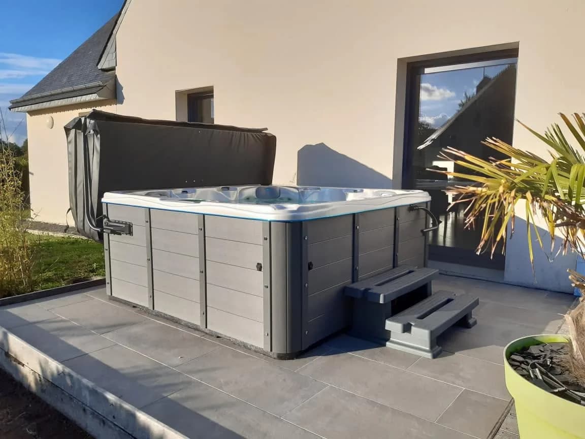 Installation d'un spa Toronto à Ploubezre, sur une terrasse devant la maison, avec marchepied