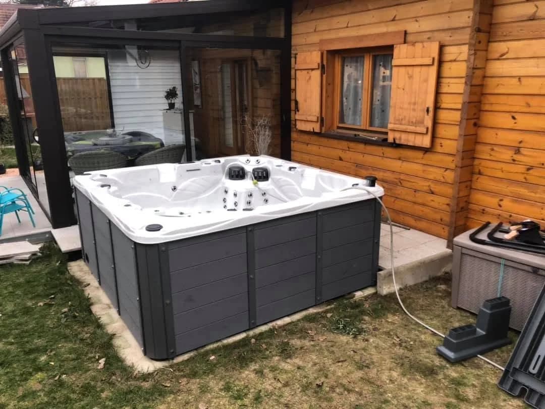 Installation d'un spa Vancouver Full option à Kingersheim, devant une maison à façade en bois
