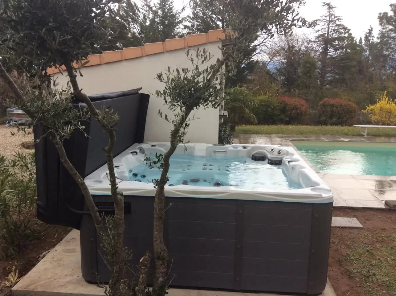Installation d'un spa Vancouver à Génissieux, près d'une piscine, lève-couverture